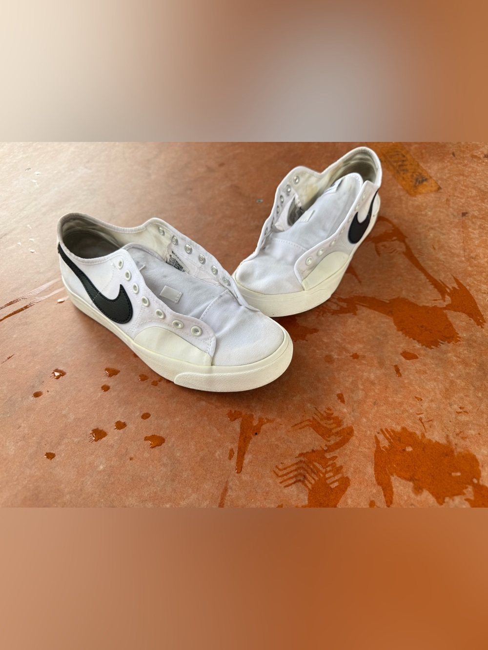 Nike Women’s White Canvas Slip-On Sneakers with Black Swoosh